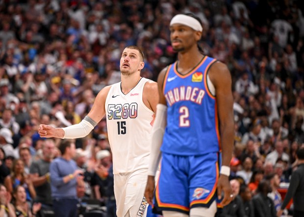 Nikola Jokic (15) of the Denver Nuggets walks behind Shai Gilgeous-Alexander (2) of the Oklahoma City Thunder during the fourth quarter of the Nuggets' 119-107 win at Ball Arena in Denver on Thursday, May 15, 2025. The Nuggets forced a game seven in their Western Conference semifinal on Sunday at Oklahoma City. (Photo by AAron Ontiveroz/The Denver Post)