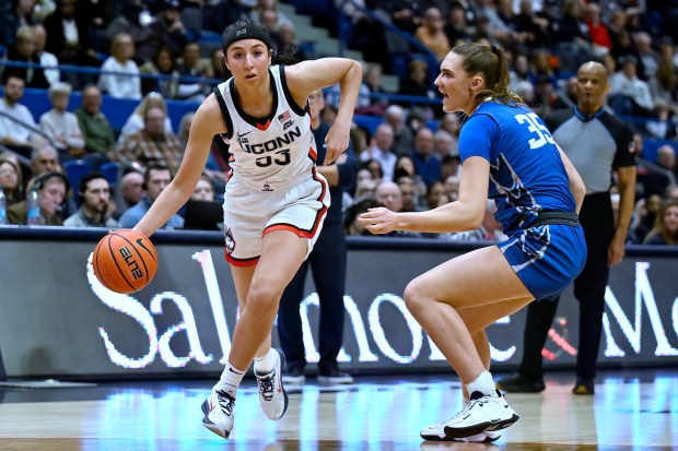 UConn guard Caroline Ducharme, left, is guarded by Creighton center Elizabeth Gentry in the second half of an NCAA college basketball game, Thursday, Feb. 27, 2025, in Hartford, Conn. (AP Photo/Jessica Hill)