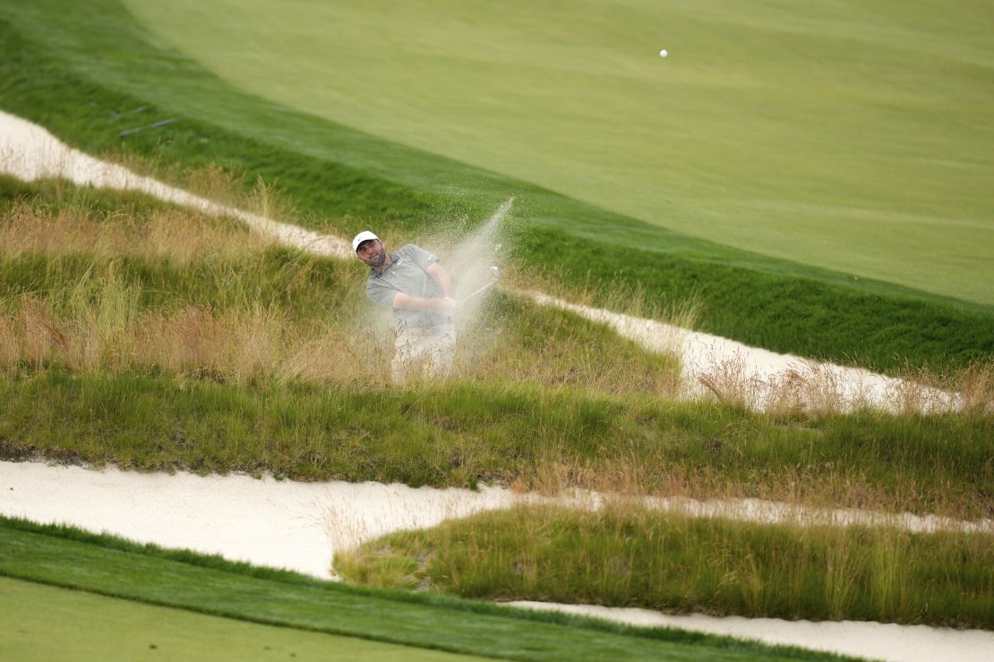 Scottie Scheffler plays out of the Church Pews bunker on the third hole during the second round.