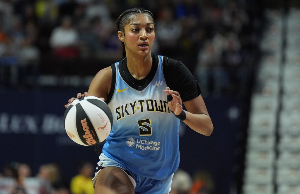 Angel Reese #5 of the Chicago Sky dribbling a basketball.