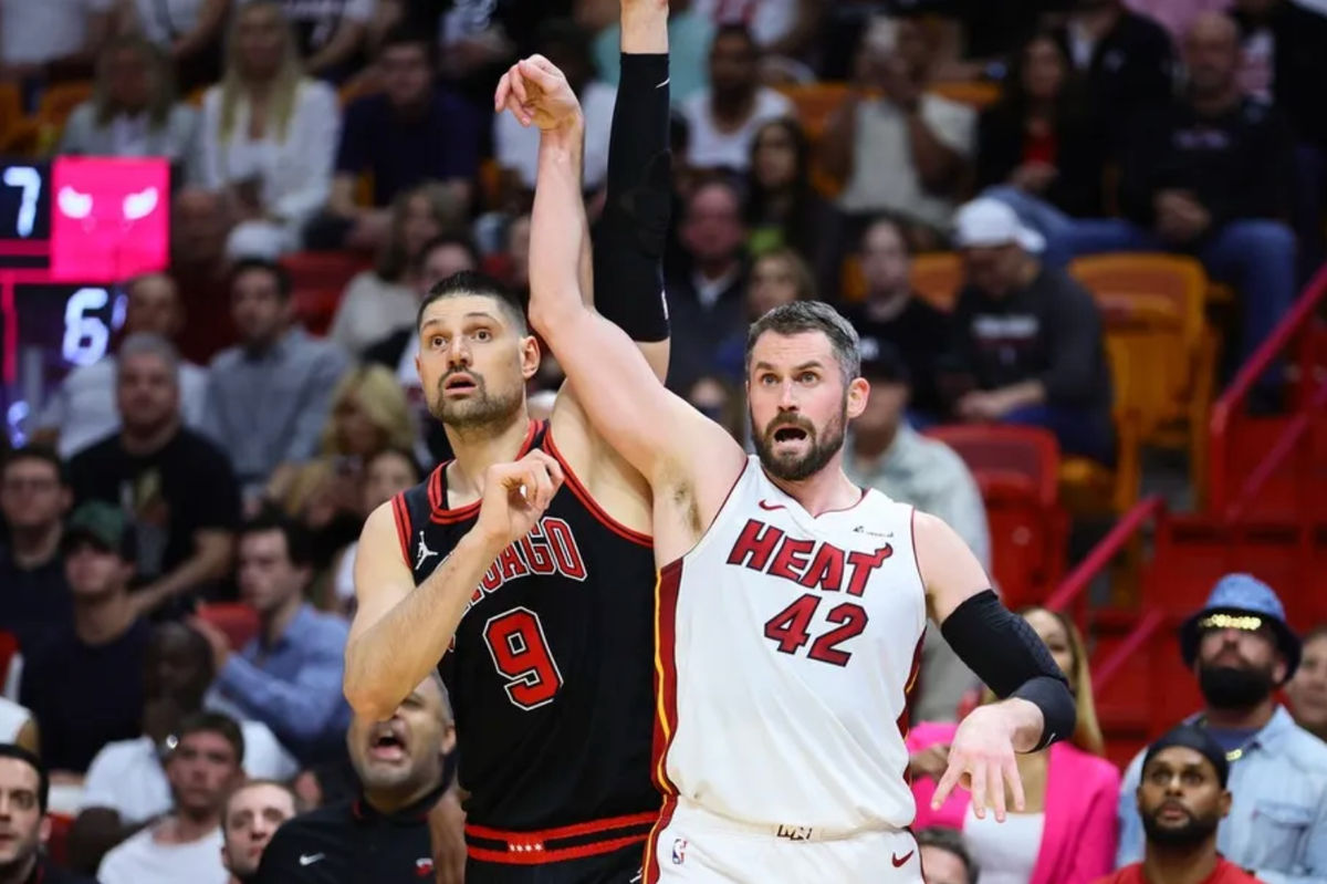Apr 19, 2024; Miami, Florida, USA; Miami Heat forward Kevin Love (42) watches his shot against Chicago Bulls center Nikola Vucevic (9) in the fourth quarter during a play-in game of the 2024 NBA playoffs at Kaseya Center. Mandatory Credit: Sam Navarro-USA TODAY Sports