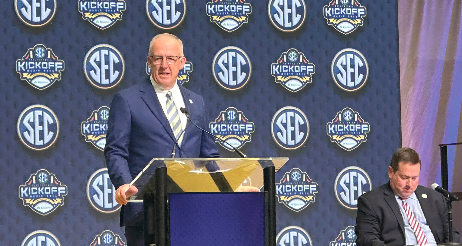 SEC Commissioner Greg Sankey, left, discusses the annual conference highlights with Chief Public Relations Officer for the University of Arkansas Kevin Trainor, sitting right, at the College Football Hall of Fame in Atlanta on Monday, July 14.