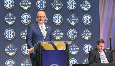 SEC Commissioner Greg Sankey, left, discusses the annual conference highlights with Chief Public Relations Officer for the University of Arkansas Kevin Trainor, sitting right, at the College Football Hall of Fame in Atlanta on Monday, July 14.