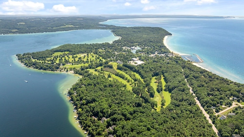 Lush golf course in your backyard in true northern Michigan? This nearly $3.5M luxury home has it all.