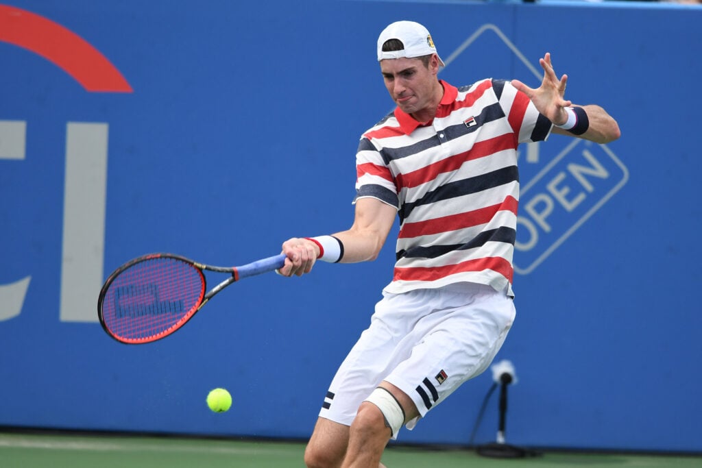 John Isner hits a forehand at the Citi Open in 2018