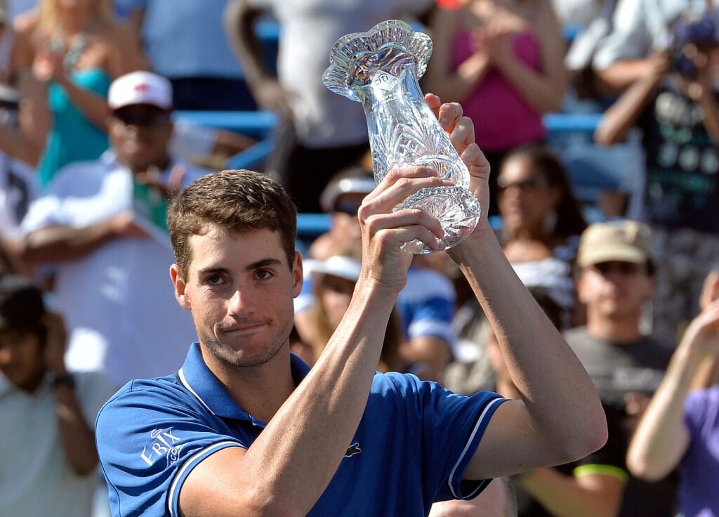 John Isner holds up the runner-up trophy at the 2013 Citi Open