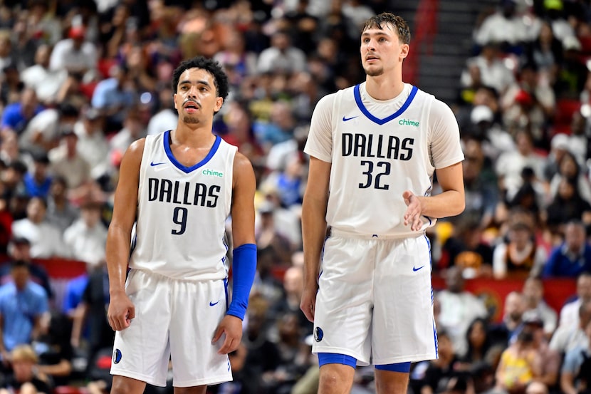 Dallas Mavericks guard Ryan Nembhard (9) and forward Cooper Flagg (32) look on during the...
