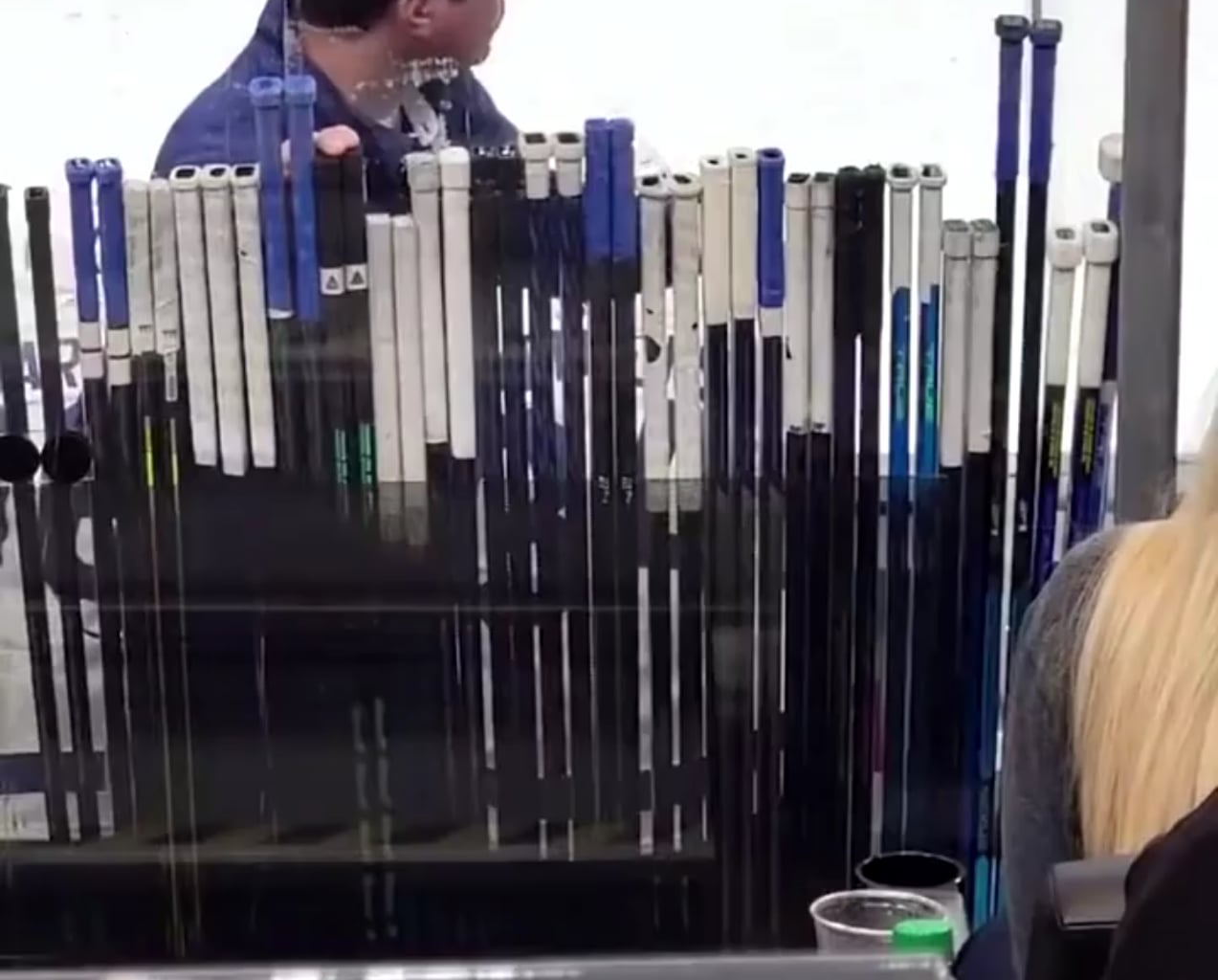 The "Stick Man" Keeps his hand on the stick of their player with the puck.