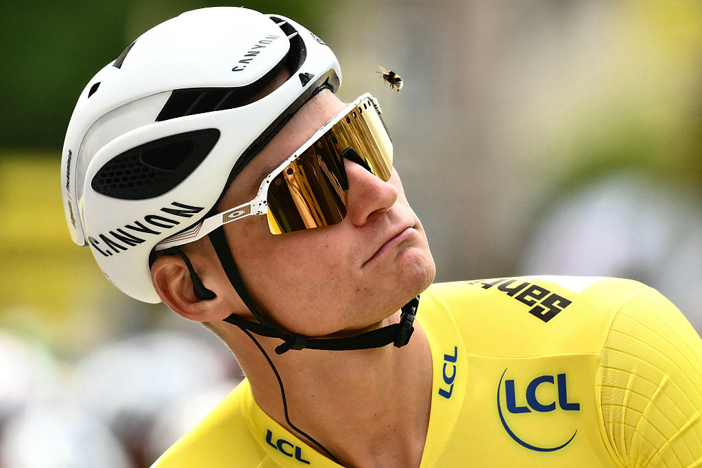 Alpecin - Deceuninck team's Dutch rider Mathieu van der Poel wearing the overall leader's yellow jersey eyes a bee flying past his head at the start of the 4th stage of the 112th edition of the Tour de France cycling race, 174.2 km between Amiens Metropole and Rouen, Northern France, on July 8, 2025. (Photo by Marco BERTORELLO / AFP)