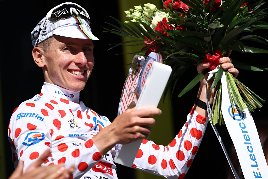 UAE Team Emirate - XRG team's Slovenian rider Tadej Pogacar celebrates on the podium with the best climber's polka dot (dotted) jersey after the 4th stage of the 112th edition of the Tour de France cycling race, 174.2 km between Amiens Metropole and Rouen, Northern France, on July 8, 2025. (Photo by Anne-Christine POUJOULAT / AFP)