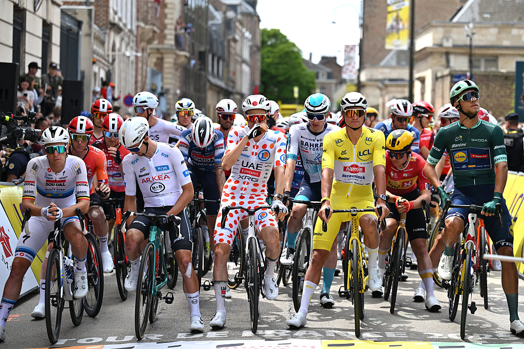 AMIENS, FRANCE - JULY 08: (L-R) Tim Merlier of Belgium and Team Soudal Quick-Step, Kevin Vauquelin of France and Team Arkea - B&B Hotels - White best young jersey, Tim Wellens of Belgium and UAE Team Emirates - XRG - Polka dot Mountain Jersey, Mathieu Van Der Poel of Netherlands and Team Alpecin - Deceuninck - Yellow leader jersey and Jonathan Milan of Italy and Team Lidl - Trek - Green Sprint Jersey prior to the 112th Tour de France, Stage 4 a 174.2km stage from Amiens Metropole to Rouen / #UCIWT / on July 08, 2025 in Amiens, France. (Photo by Tim de Waele/Getty Images)