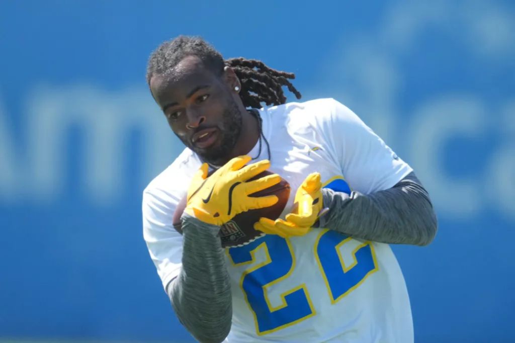 An image collage containing 1 images, Image 1 shows Los Angeles Chargers running back Najee Harris (#22) catching a football during an offseason workout