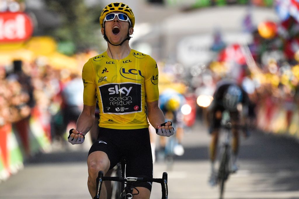 TOPSHOT - Great Britain's Geraint Thomas, wearing the overall leader's yellow jersey, celebrates as he crosses the finish line to win the twelfth stage of the 105th edition of the Tour de France cycling race, between Bourg-Saint-Maurice - Les Arcs and l'Alpe d'Huez, on July 19, 2018. (Photo by Marco BERTORELLO / AFP) (Photo credit should read MARCO BERTORELLO/AFP via Getty Images)