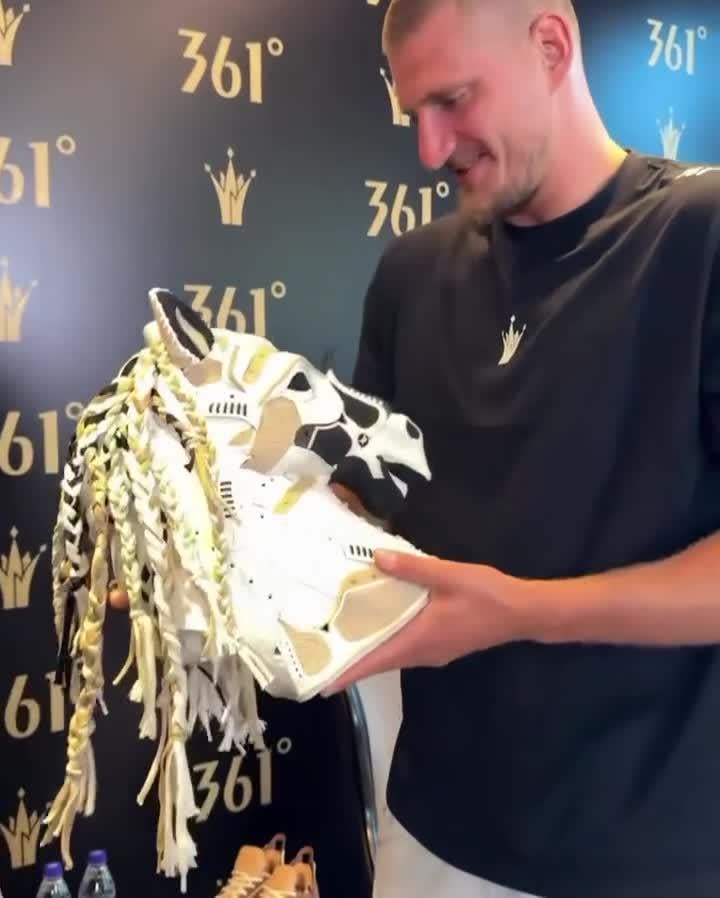 Nikola Jokic receives a horse head made from his shoes while on his tour of China