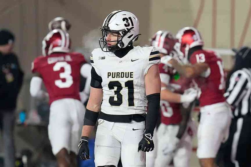FILE - Purdue defensive back Dillon Thieneman (31), who has since transferred to Oregon, walks off the field as Indiana players celebrate after a touchdown during the second half of an NCAA college football game, Saturday, Nov. 30, 2024, in Bloomington, Ind. (AP Photo/Darron Cummings, File(