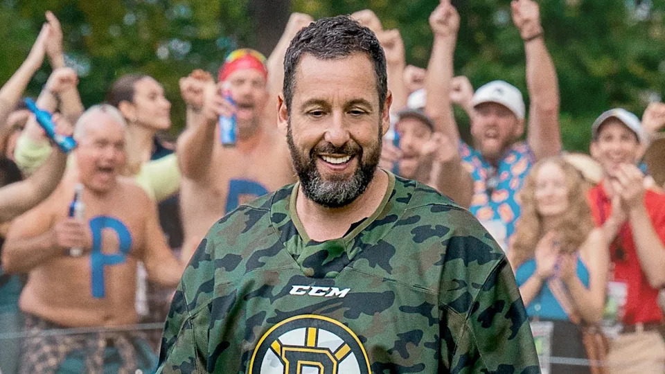  Happy smiling in front of a cheering crowd in Happy Gilmore 2. 