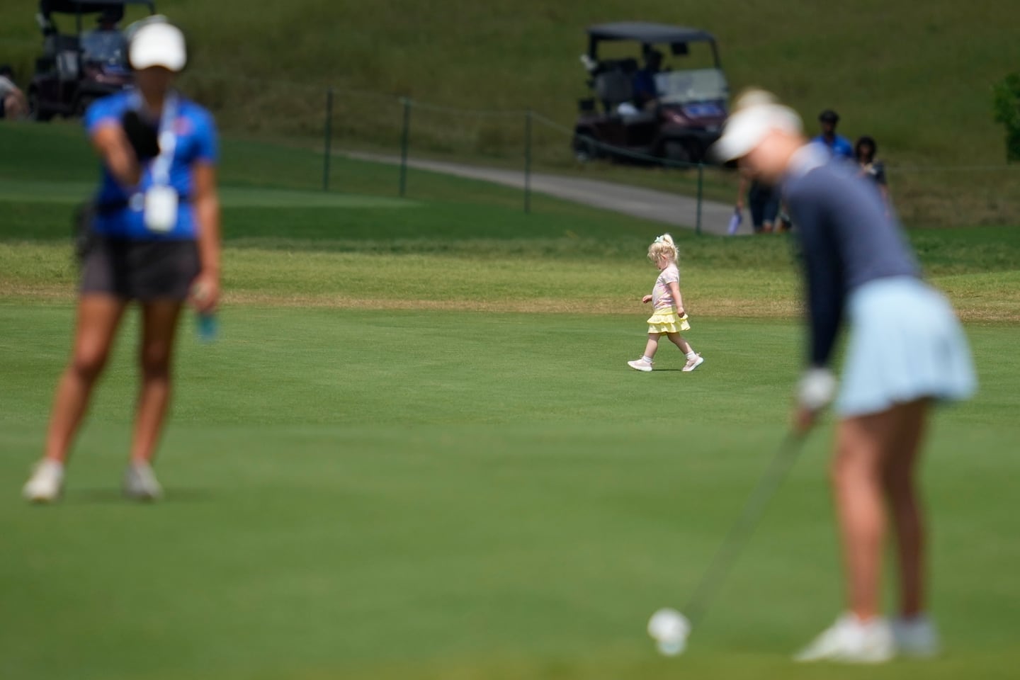 A child walks across a fairway during an April tournament in Texas.