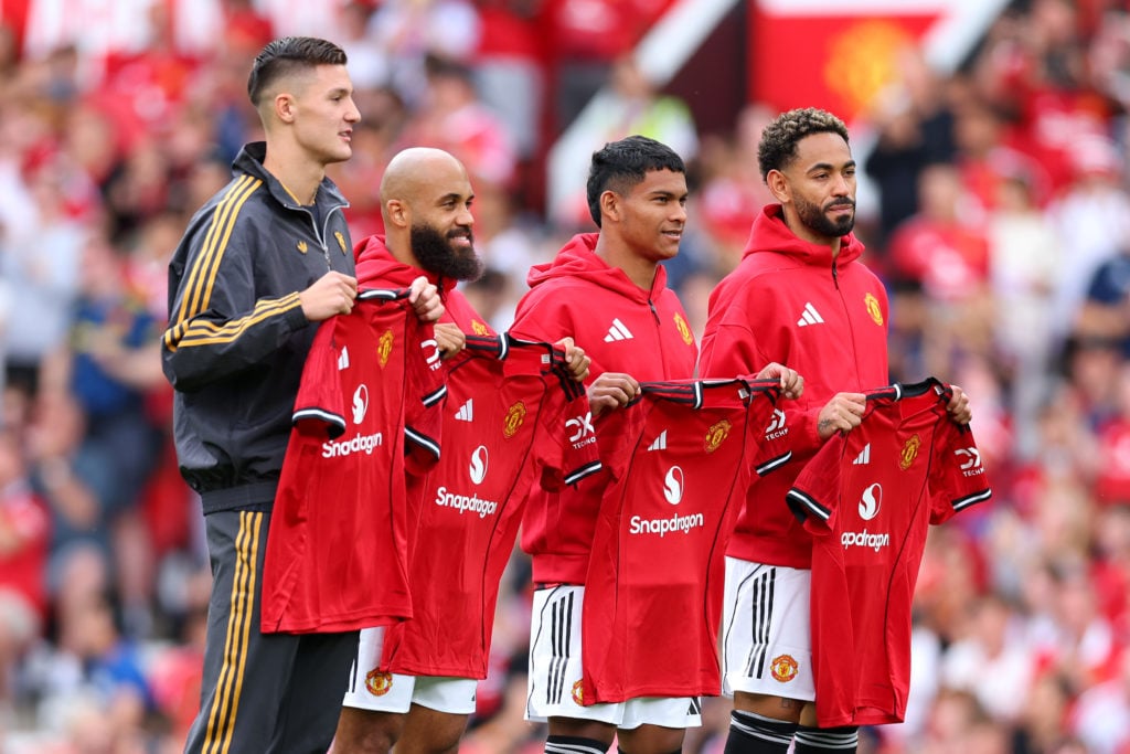 New signings Bryan Mbeumo, Benjamin Sesko, Diego Leon and Matheus Cunha pose for a photo while holding match shirts prior to the pre-season friendly match between Manchester United and Fiorentina at Old Trafford in 2025 in Manchester, England.