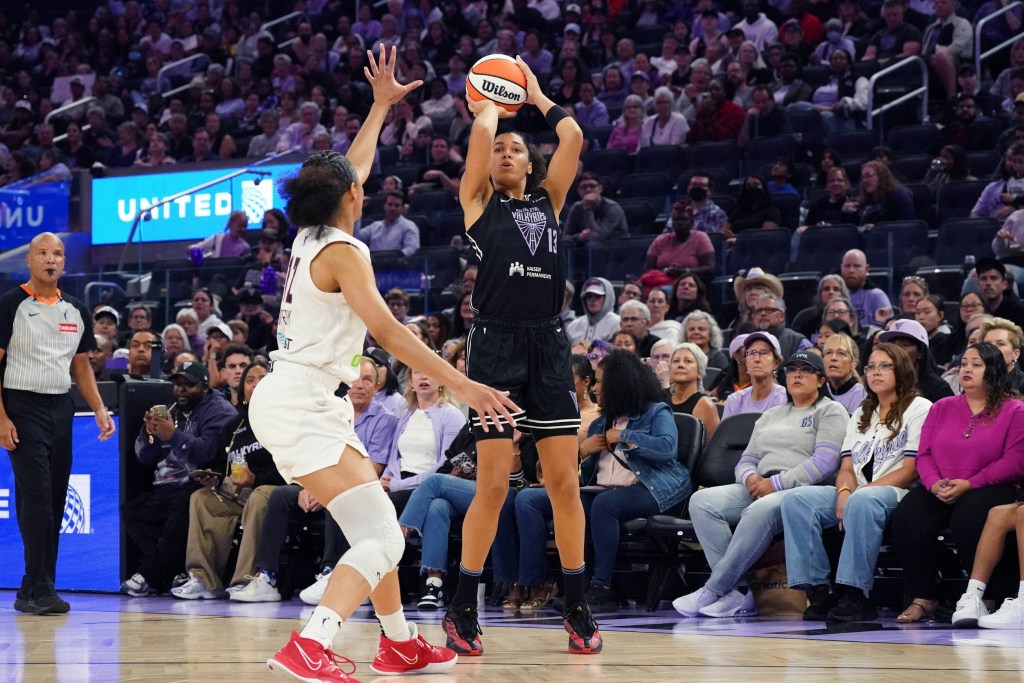 Golden State Valkyries forward Janelle Salaun shoots a three pointer. She is shown from the front with a large crowd behind her.