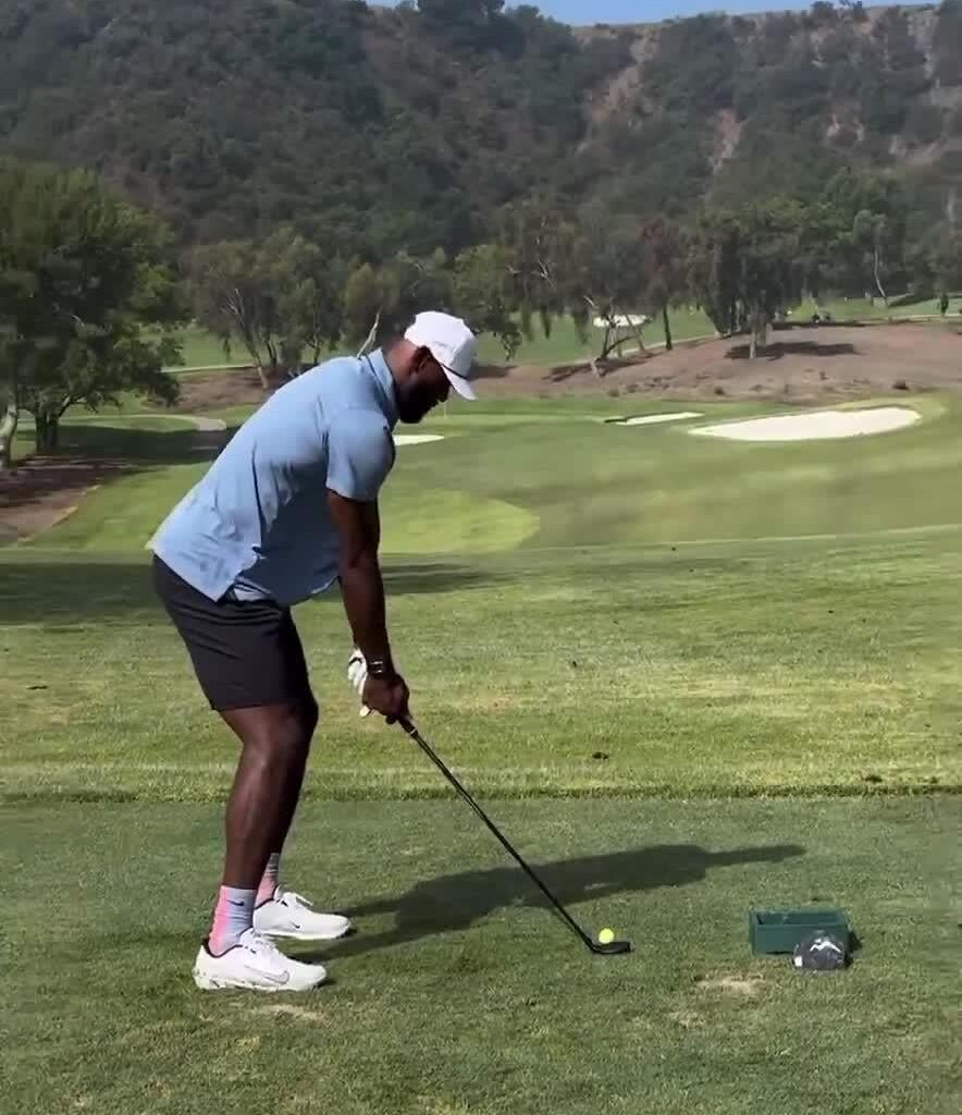 Lebron wearing Miami Vice City-Edition colored socks while golfing