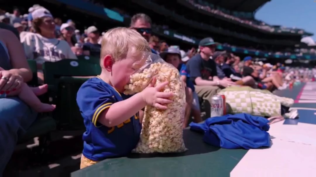 This child at the Mariners game achieving unimaginable bliss