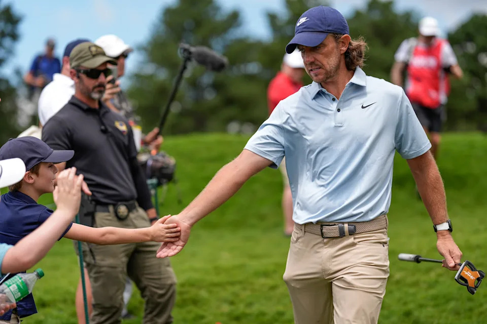 Tommy Fleetwood, of England, greets fans off the fourth tee during the final round of the Tour Championship golf tournament, Sunday, Aug. 24, 2025, in Atlanta. (AP Photo/Mike Stewart)
