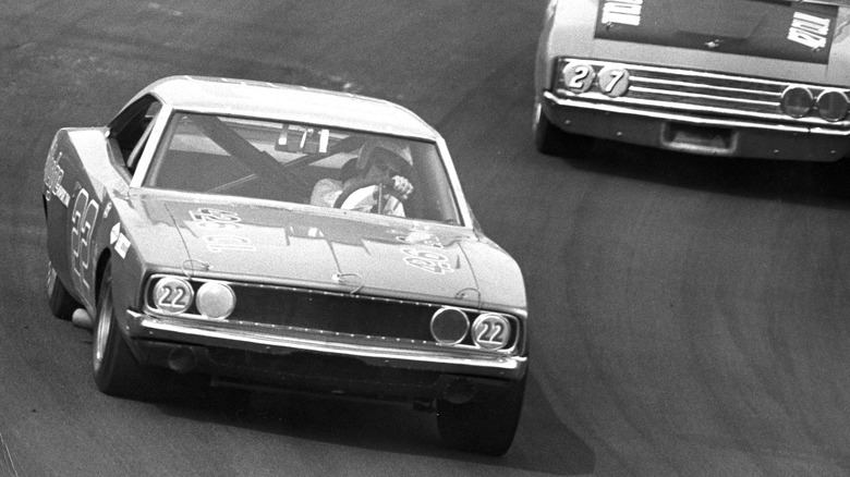 Bobby Allison races in black and white old photo