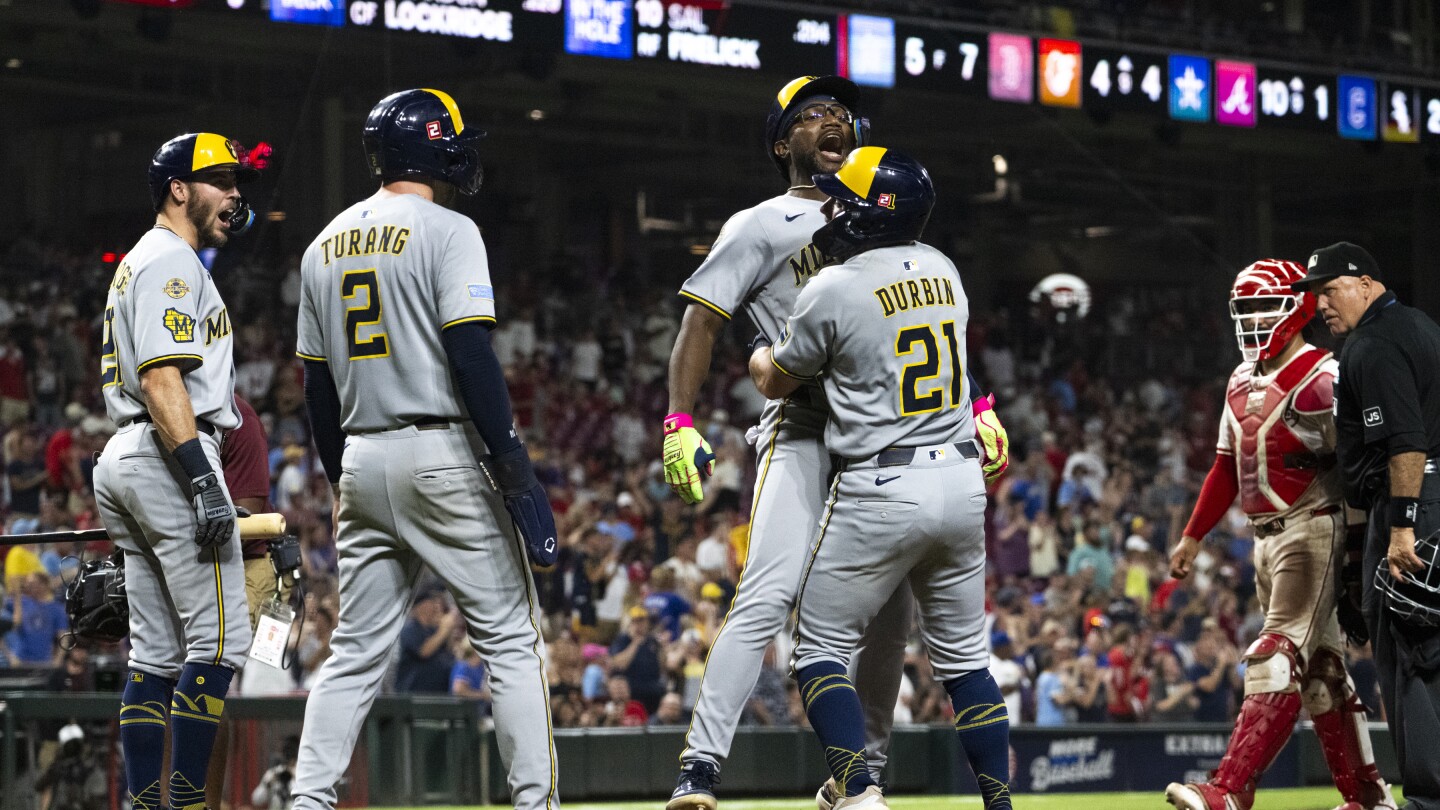 Brewers win 14th straight by beating Reds in 11 innings