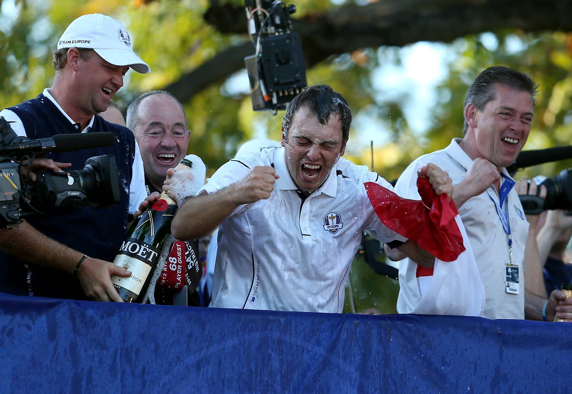MEDINAH, IL - SEPTEMBER 30:  Francesco Molinari (C)  and Peter Hanson celebrate after Europe defeated the USA 14.5 to 13.5 to retain the Ryder Cup during the Singles Matches for The 39th Ryder Cup at Medinah Country Club on September 30, 2012 in Medinah, Illinois.  (Photo by Andy Lyons/Getty Images)