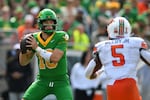 Oregon quarterback Luke Moga (10) drops back to pass in front of Oklahoma State Cowboys linebacker Bryan McCoy Jr. (5) during an NCAA football game on Saturday, Sept. 6, 2025, in Eugene, Ore.
