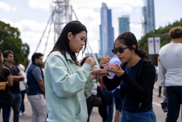 Fest participants share food items, Sept. 7, 2025, during the Taste of Chicago in Grant Park. (Brian Cassella/Chicago Tribune)