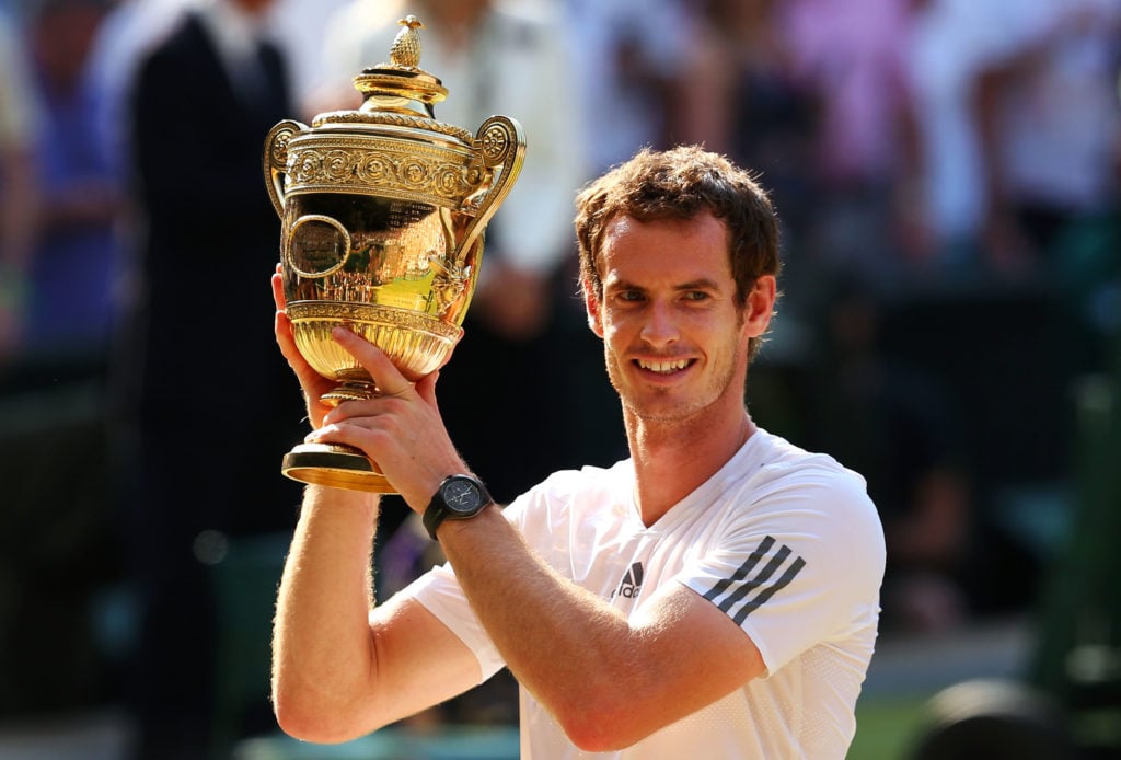 Andy Murray poses with the trophy after beating Novak Djokovic in the 2013 Wimbledon final