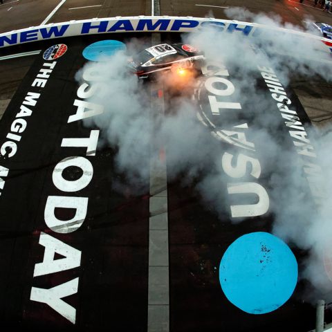Christopher Bell, driver of the No. 20 Joe Gibbs Racing Toyota, celebrates with a burnout after winner the NASCAR Cup Series race at New Hampshire Motor Speedway on June 23, 2024.