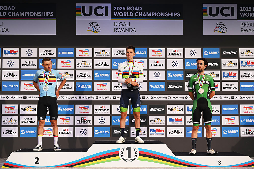KIGALI, RWANDA - SEPTEMBER 28: (L-R) Silver medalist Remco Evenepoel and Team Belgium, gold medalist Tadej Pogacar and Team Slovenia and bronze medalist Ben Healy and Team Ireland pose on the podium during the medal ceremony after the 98th UCI Cycling World Championships Kigali 2025, Men Elite Road Race a 267.5km race from Kigali to Kigali on September 28, 2025 in Kigali, Rwanda. (Photo by Dario Belingheri/Getty Images)