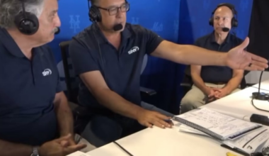 Mets broadcast booth fuming while the Marlins take a team picture together after ending their season