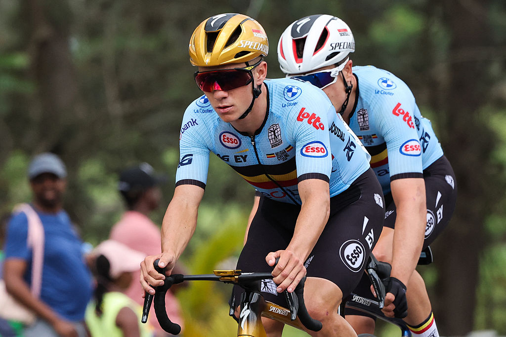 Belgian rider Remco Evenepoel (L) competes in the men's Elite road race cycling event during the UCI 2025 Road World Championships, in Kigali, on September 28, 2025. (Photo by Anne-Christine POUJOULAT / AFP)