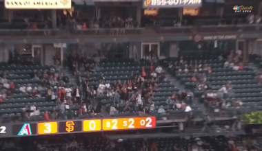 Adult San Francisco Giants fan catches ball in stands and gives to young fan near him