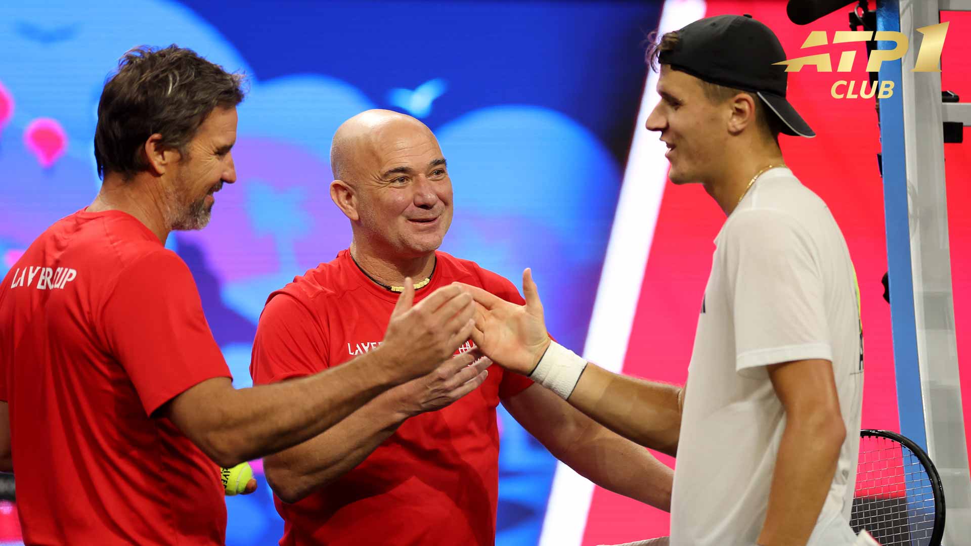 Team World captain Andre Agassi (middle) and vice captain Patrick Rafter (left) greet Jakub Mensik.