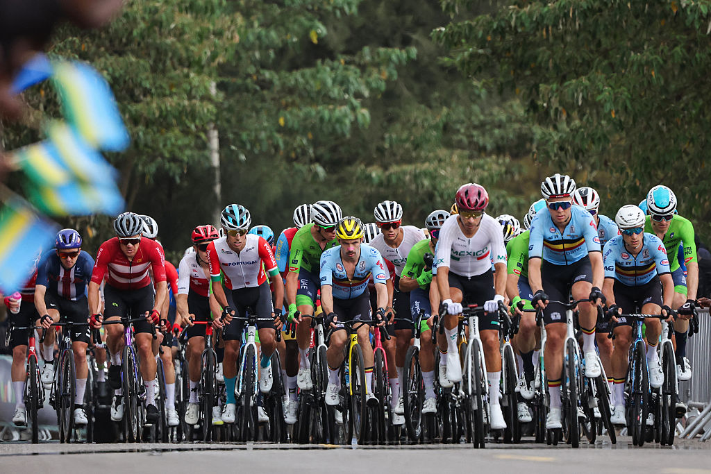 The pack of riders (peloton) cycle in the men's Elite road race cycling event during the UCI 2025 Road World Championships, in Kigali, on September 28, 2025. (Photo by Anne-Christine POUJOULAT / AFP)
