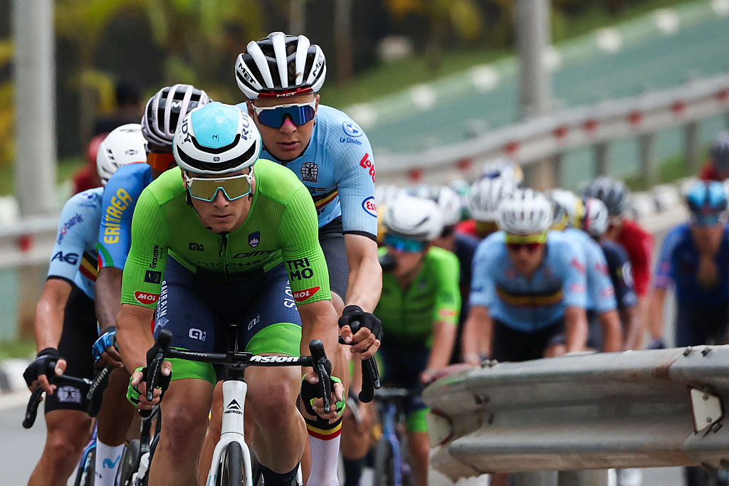 A Slovenian team member leads the pack of riders (peloton) in the men's Elite road race cycling event during the UCI 2025 Road World Championships, in Kigali, on September 28, 2025. (Photo by Anne-Christine POUJOULAT / AFP)