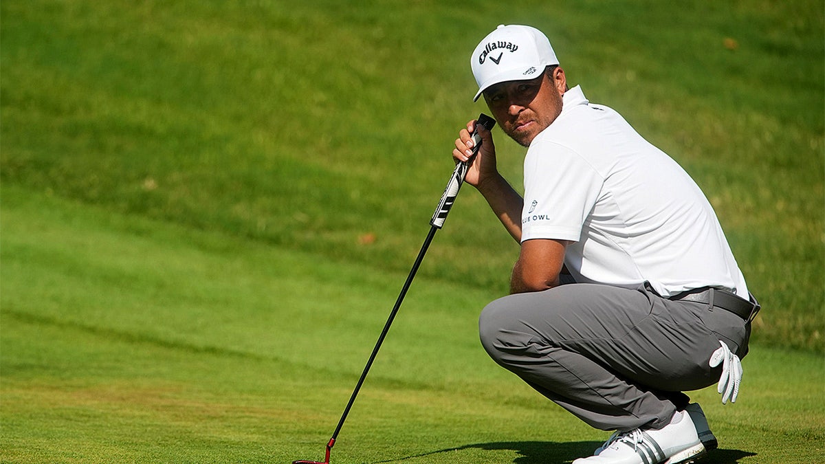 Xander Schauffele looks on