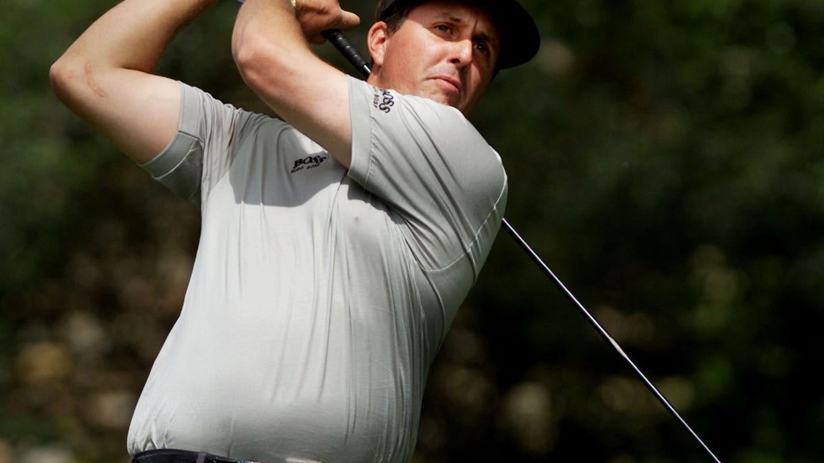Phil Mickelson of the United States hits his tee shot on the second hole during third round play at ..