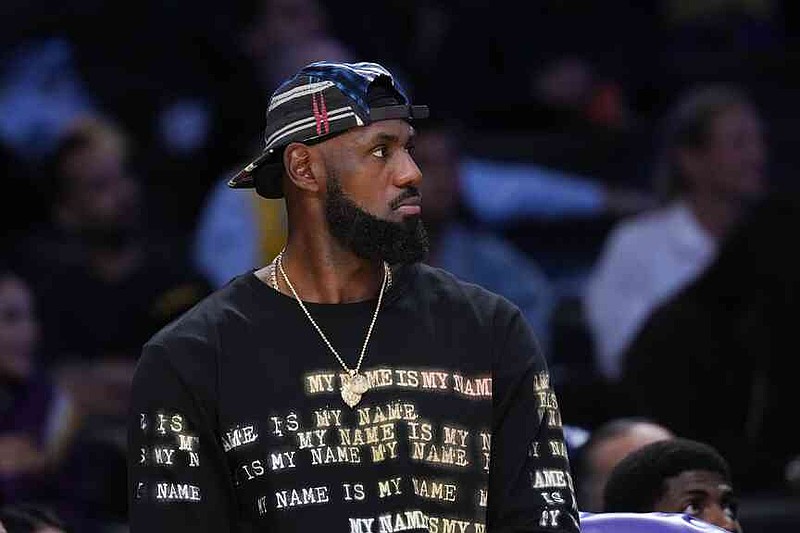 Los Angeles Lakers' Lebron James watches action from the bench during the first half of a preseason NBA basketball game against the Sacramento Kings Friday, Oct. 17, 2025, in Los Angeles. (AP Photo/Jae C. Hong)