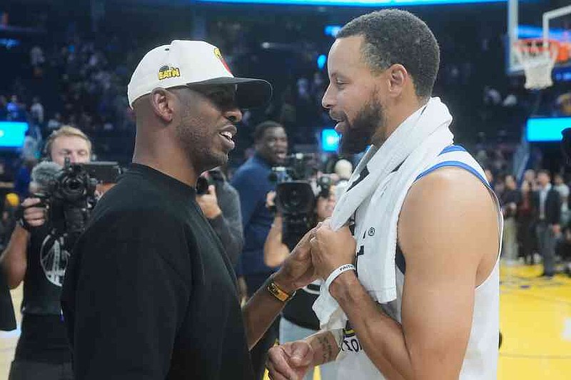 Los Angeles Clippers guard Chris Paul, left, talks with Golden State Warriors guard Stephen Curry after an NBA preseason basketball game in San Francisco, Friday, Oct. 17, 2025. (AP Photo/Jeff Chiu)