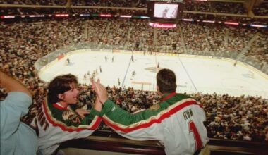 Minnesota Wild fans exchange high fives after the team scores its first ever goal - September 29, 2000
