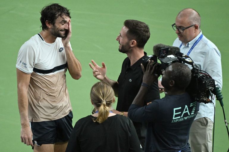 Monacos Valentin Vacherot (L) reacts during an interview after winning the mens singles semi-final match against Serbias Novak Djokovic at the Shanghai Masters tennis tournament in Shanghai on October 11, 2025. (Photo by Jade Gao / AFP)