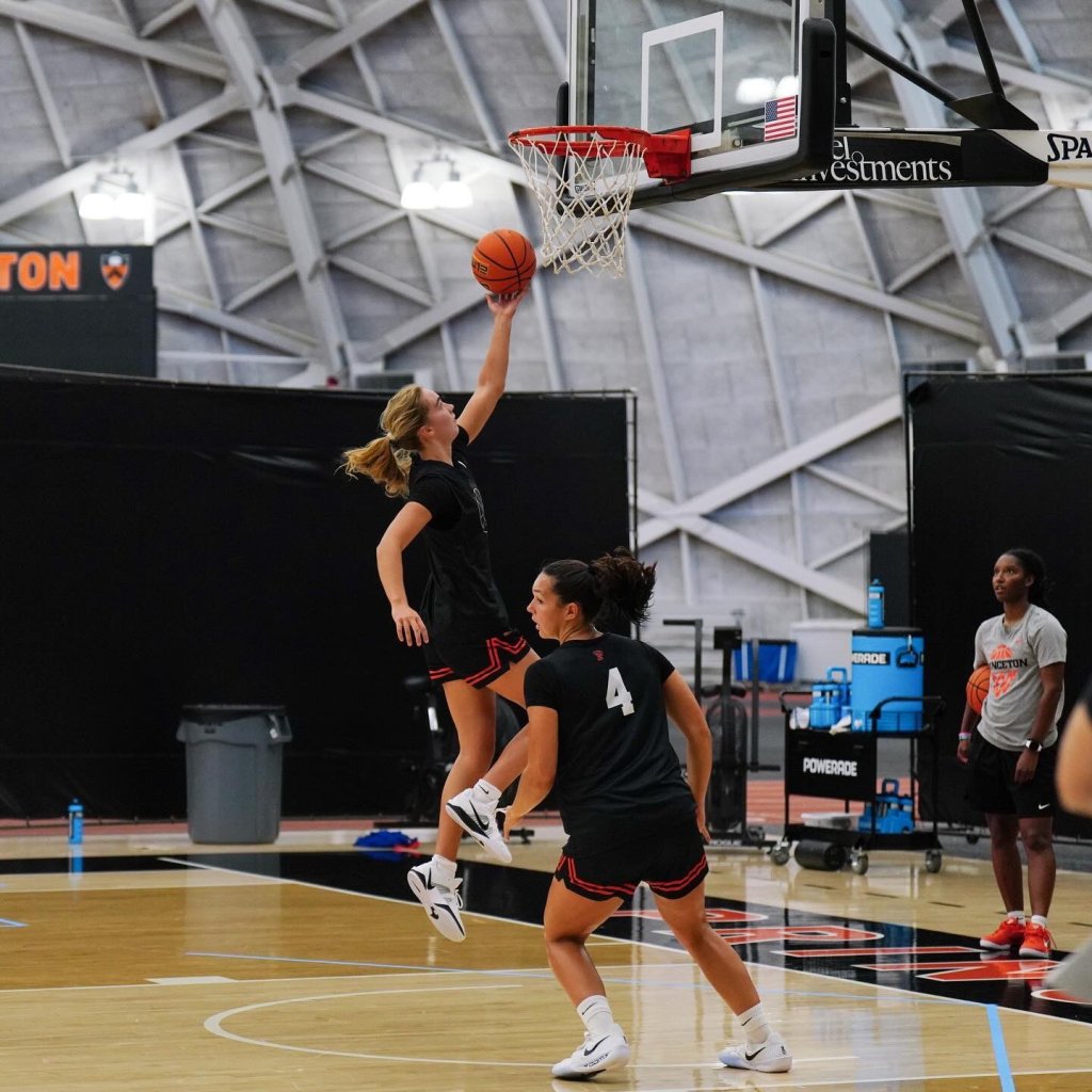 Princeton first-year Sarah Lessig is shown in midair, about to release a left-handed layup.