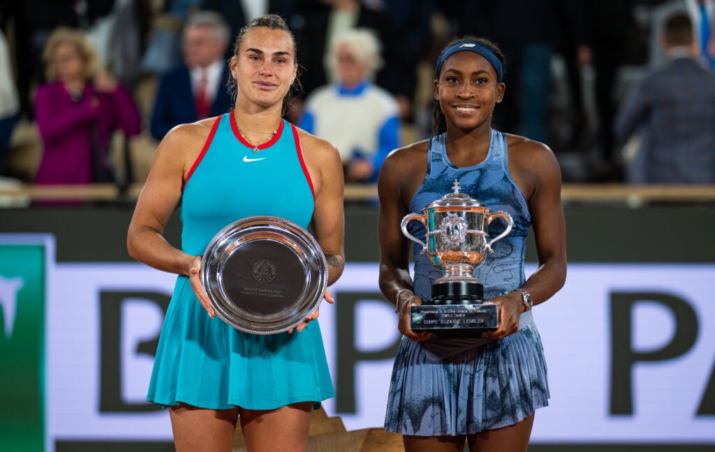 Aryna Sabalenka and champion Coco Gauff of the United States pose with their trophies after the womens singles final on Day Fourteen of the French Open at Roland Garros.