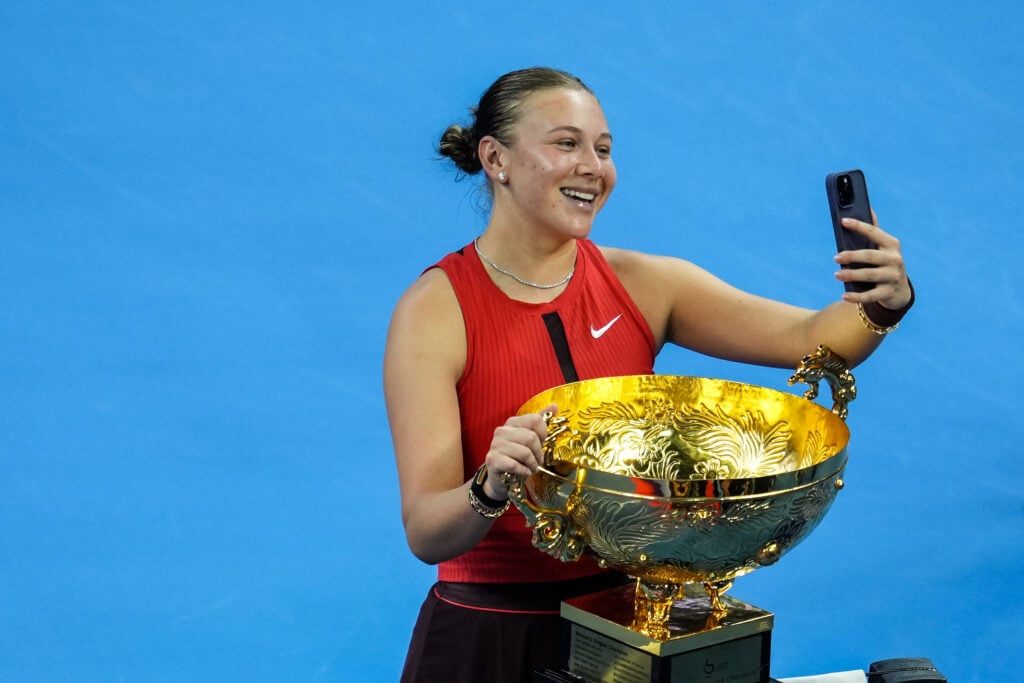 Amanda Anisimova of the United States celebrates with the trophy on medal ceremony after winning the Women's Singles Final match against Linda Noskova of Czech Republic on day 14 of 2025 China Open at National Tennis Center.