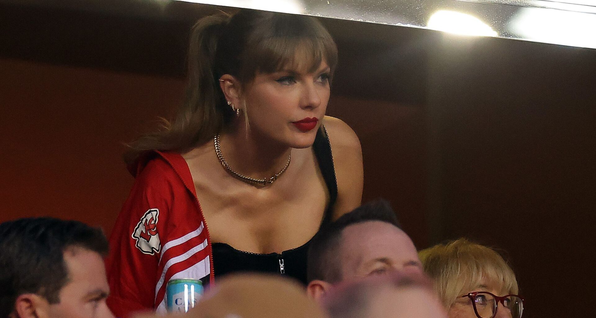 Taylor Swift attending the Kansas City Chiefs game wearing a vintage jacket